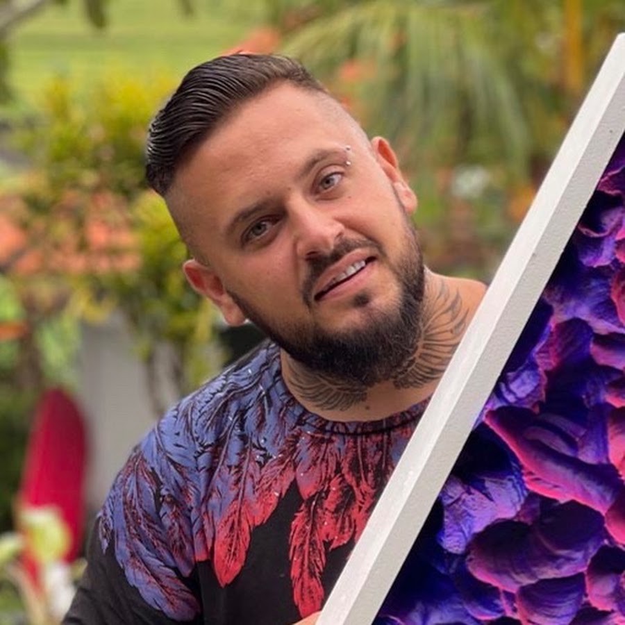 Alex Creator holding a purple and blue floral canvas