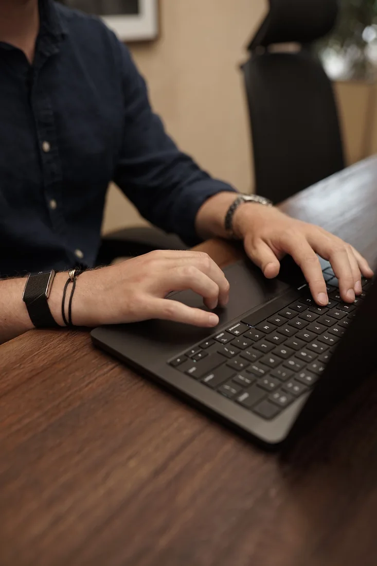 Working on a laptop at the BlackFire desk