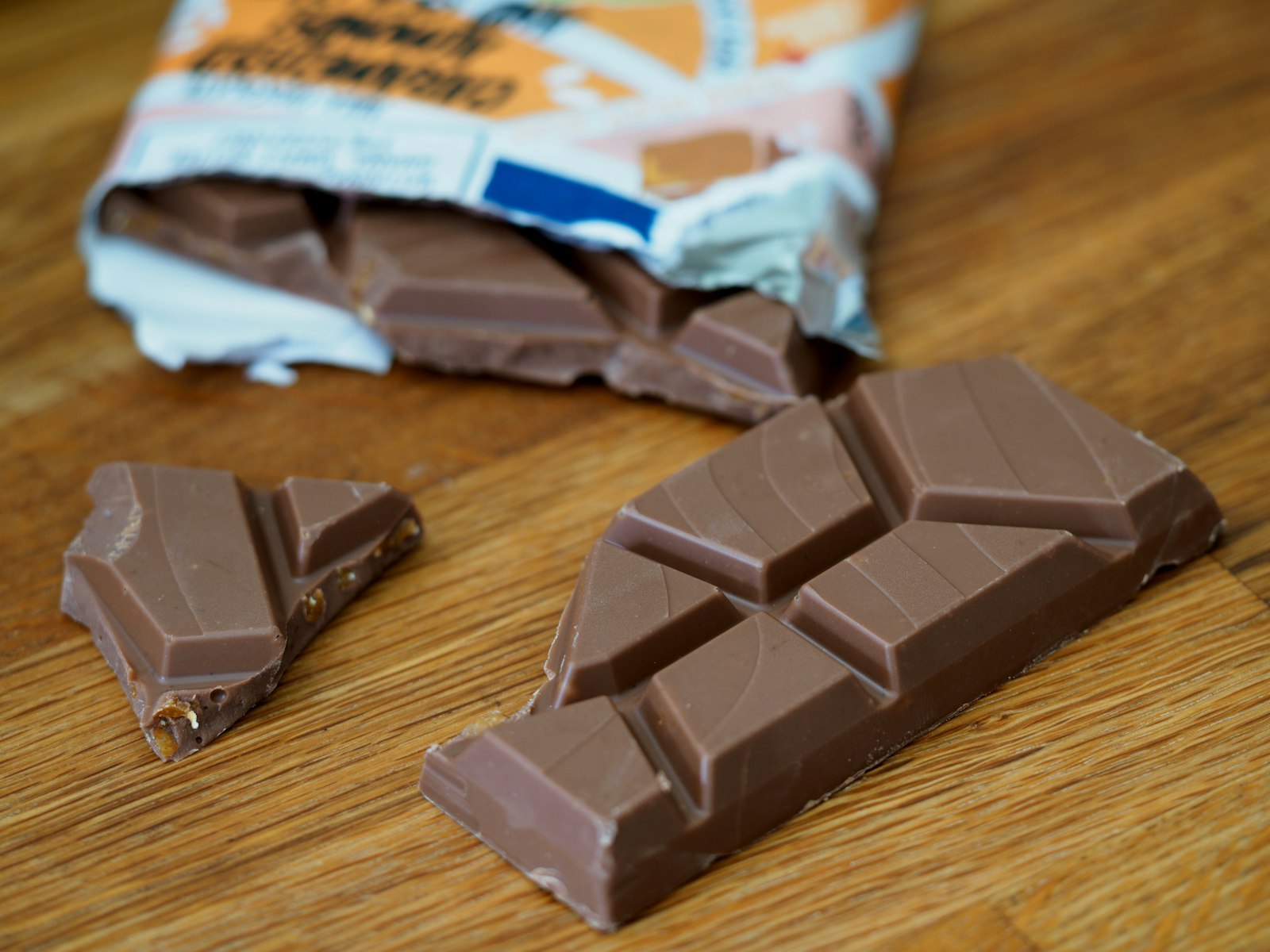 Close-up of an indulgent chocolate bar on a wooden surface, suggesting the brand-feeling territory Cadbury leaned into with the Gorilla campaign.