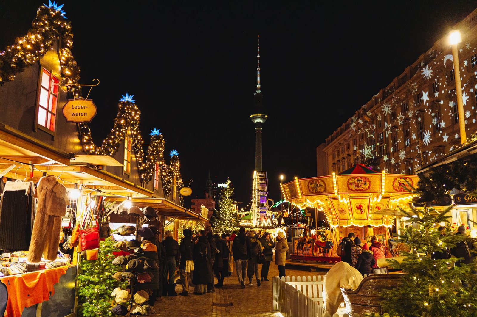 A crowded Christmas market at night under festive lights, the kind of shared seasonal moment a truck tour turns into a place people can visit.