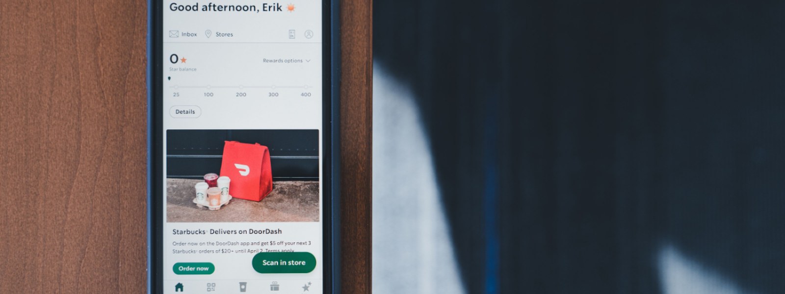 Smartphone screen showing the DoorDash app, with a Starbucks delivery promotion on screen