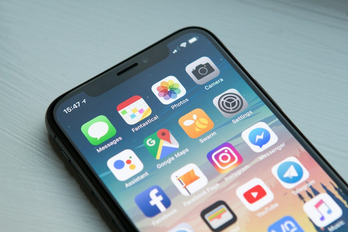 Smartphone home screen with the Google Maps app icon visible among social and utility apps, illustrating how UK customers find local businesses on Maps.