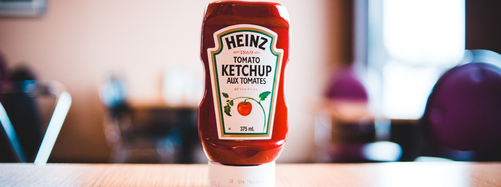 A bottle of Heinz Tomato Ketchup on a table
