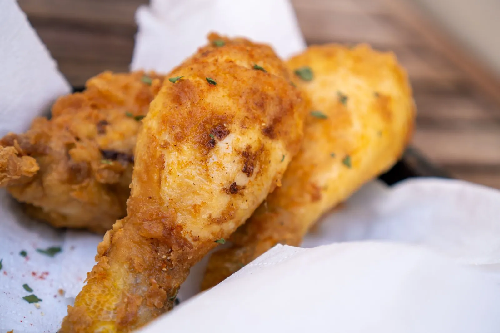 Golden fried chicken drumsticks on white paper, a nod to the product KFC ran out of during the 2018 chicken crisis that led to the FCK ad.