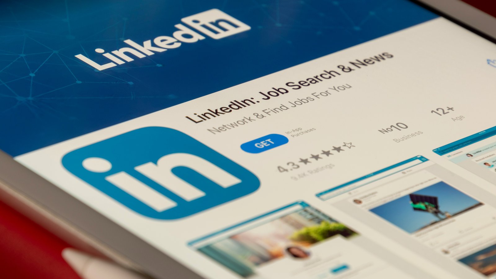 A tablet screen showing the LinkedIn app logo and feed