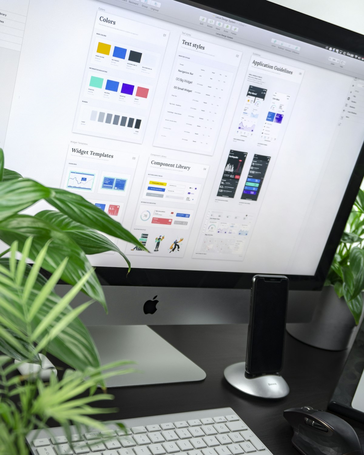 iMac on a desk showing a modular design system with colour palettes, text styles and UI components, representing modular Meta ad creative assets for Advantage+ automation.