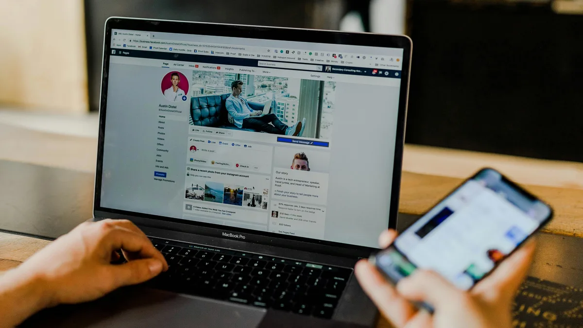 A laptop open on a Facebook business page next to a smartphone, showing organic social content