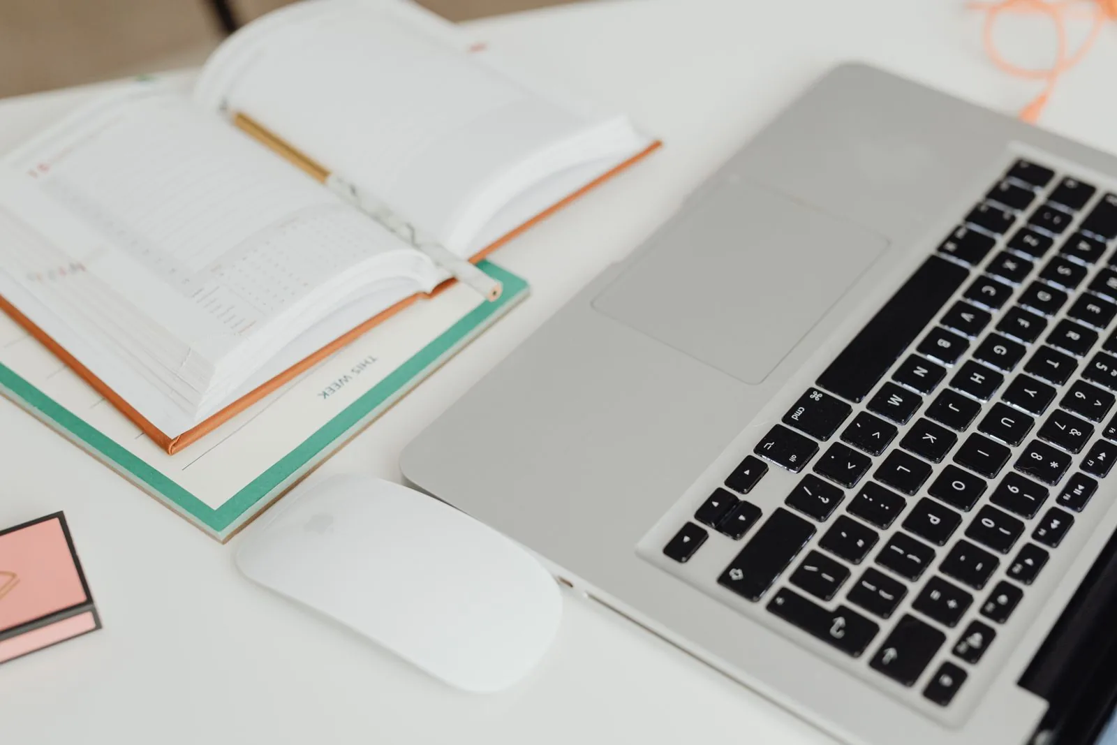 An open planner and calendar beside a laptop on a tidy white desk, a reminder to diary the day 30 review for TikTok Shop Net Sales Boost before standard fees start.