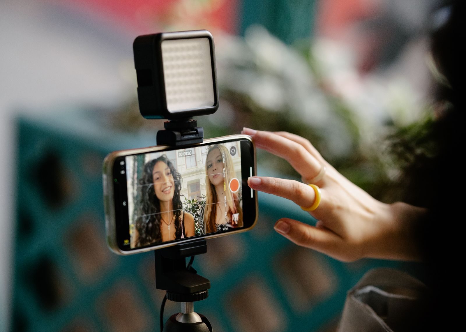 UGC creator filming a vertical video on a smartphone in natural light