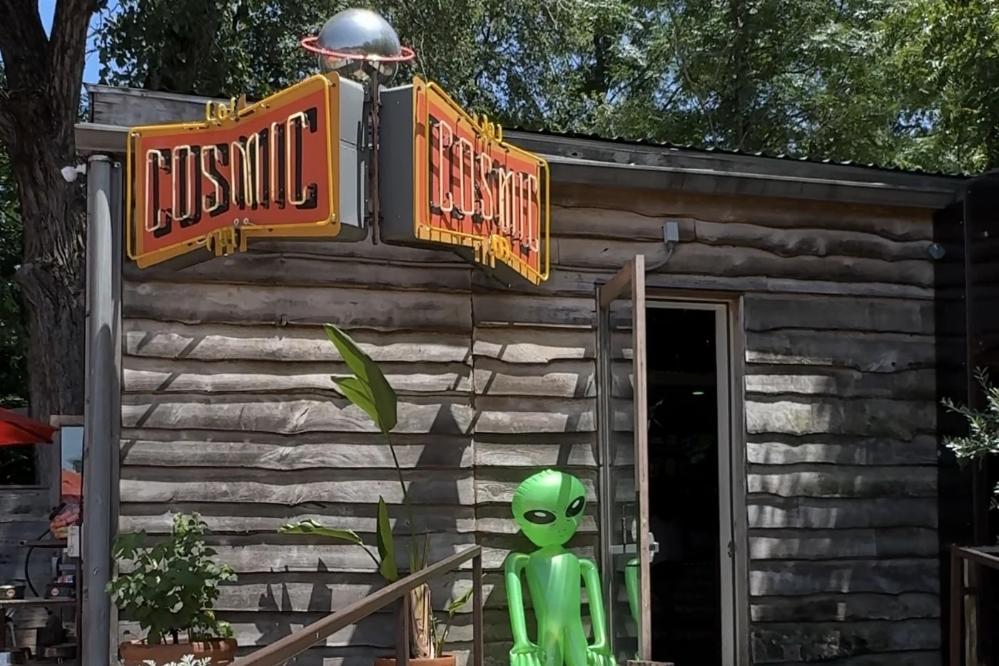 The entrance and neon sign at Cosmic Pickle