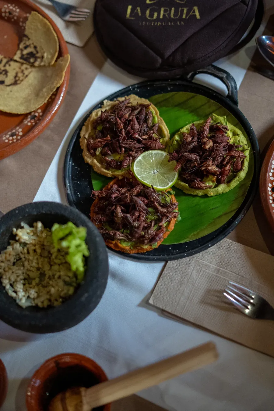 Chapulines tostadas served on a banana leaf